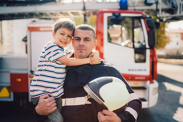 firefighter holding child